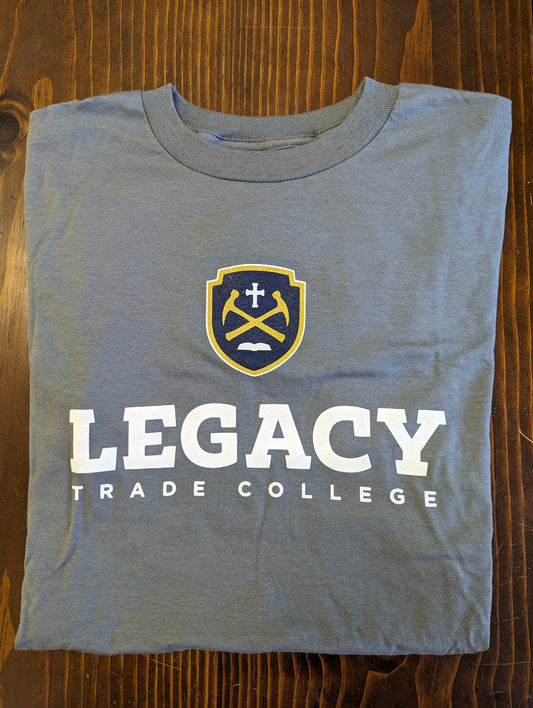 "Legacy Trade College" in white. Blue and gold shield with hammers, cross, and Bible.